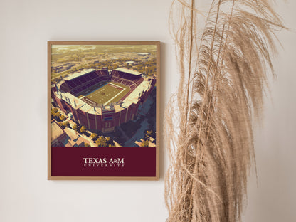 A framed poster of Kyle Field at Texas A&M University hangs on a white wall beside tall, dried grass. The artwork features the stadiums aerial view with bold colors.