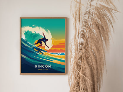 A framed poster features a surfer riding a vibrant wave against a colorful sunset background, with the text Rincon Puerto Rico below. Pampas grass decorates the right side.