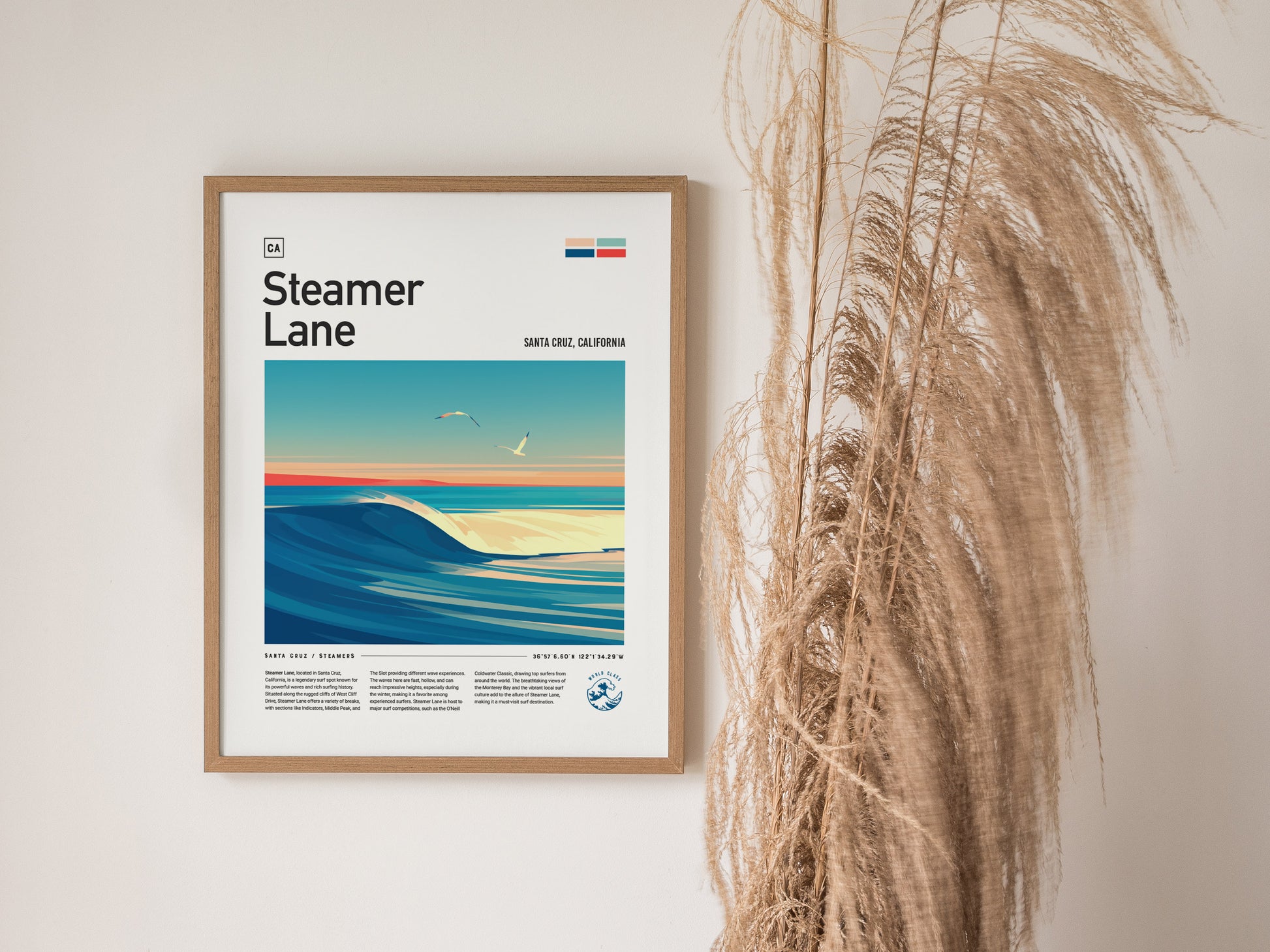 Framed Steamer Lane poster depicting a vibrant ocean wave with seagulls above, hanging on a wall beside tall, dried grasses. The artwork captures a serene coastal scene.