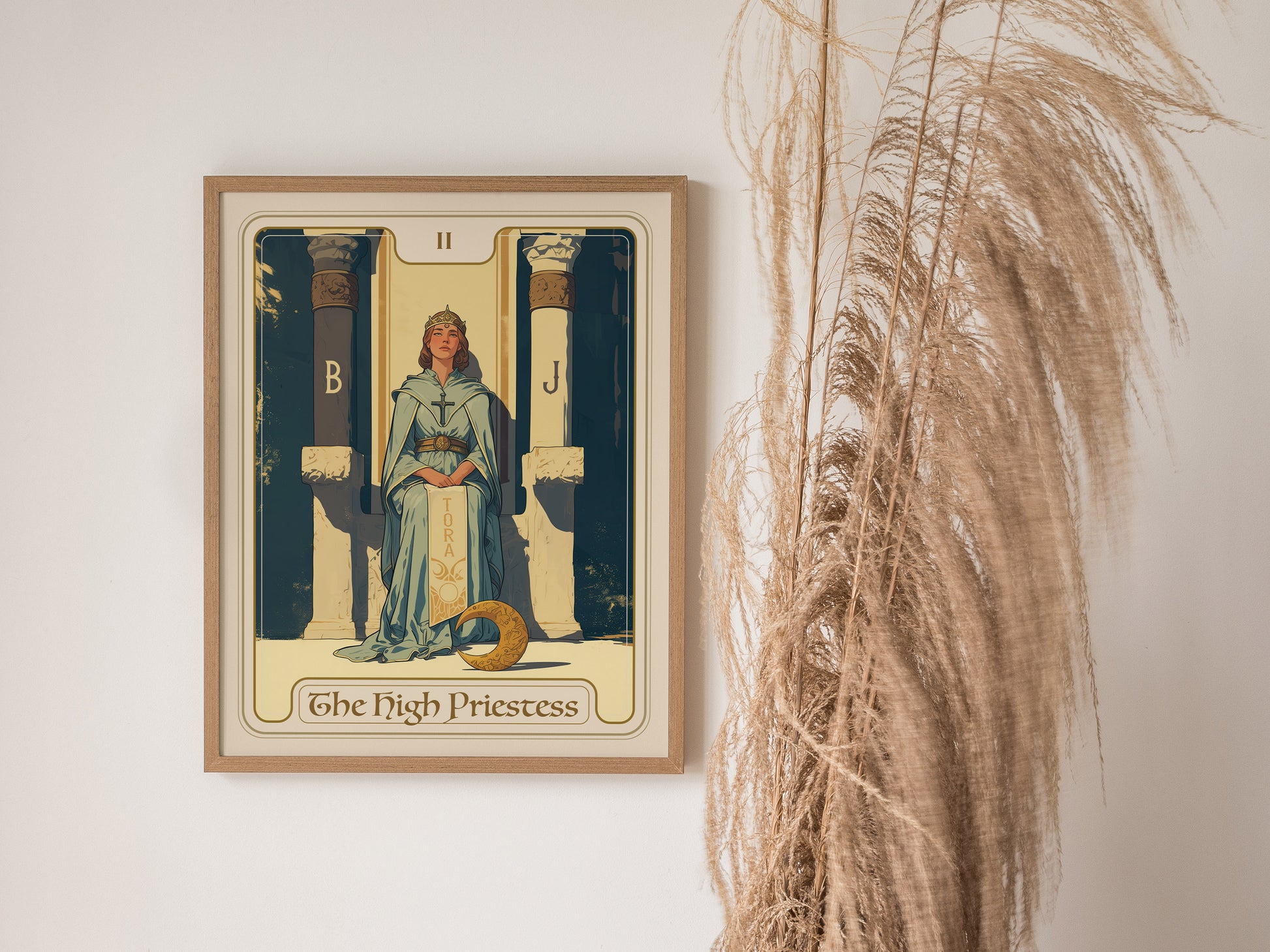 Framed High Priestess tarot card poster featuring a serene figure between two pillars, labeled B and J, with pampas grass nearby. A TORA scroll and crescent moon are visible.