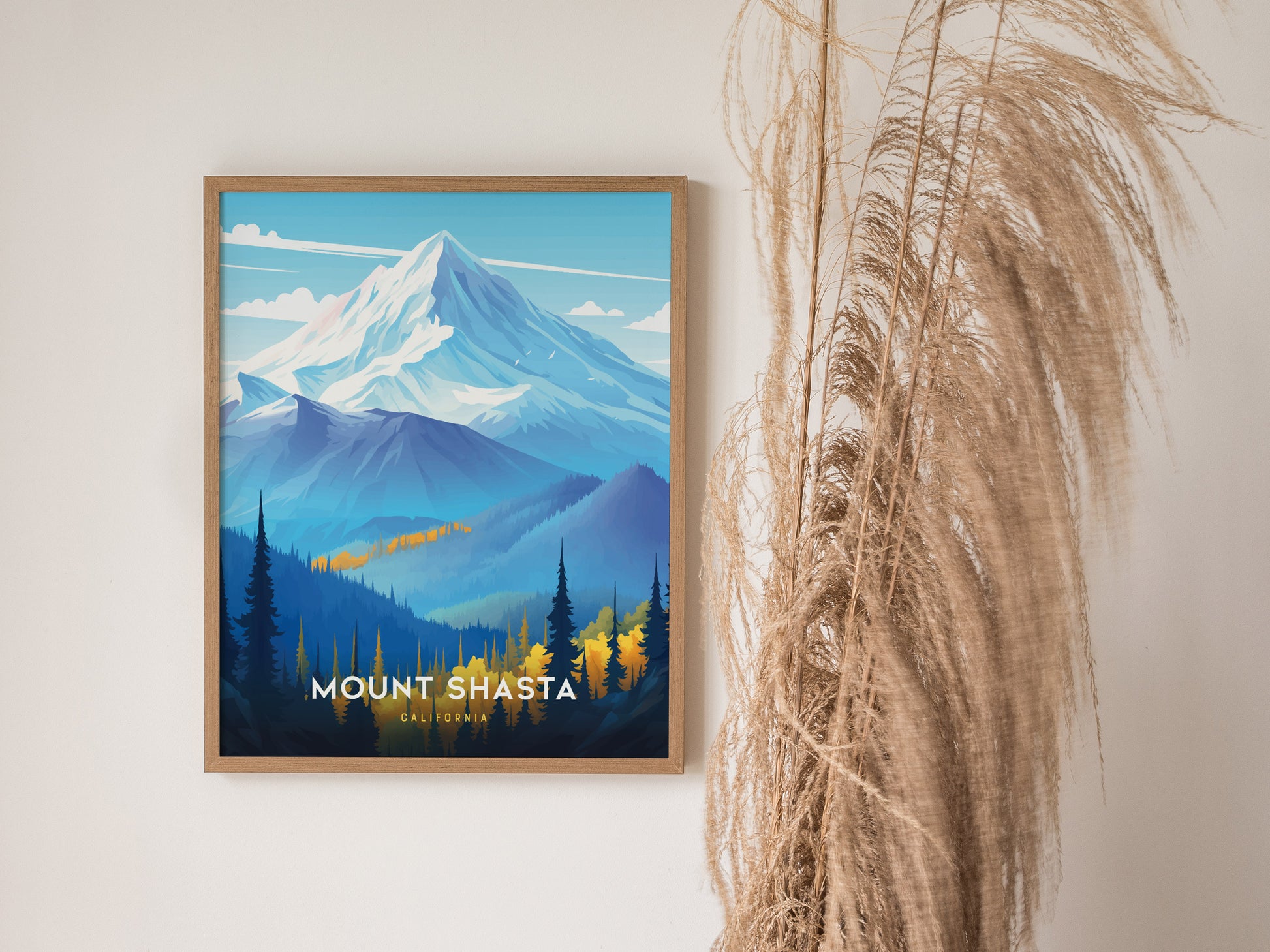 A framed poster of Mount Shasta features a snow-capped peak with blue and yellow forested foothills. Dried pampas grass decorates the right side of the image.