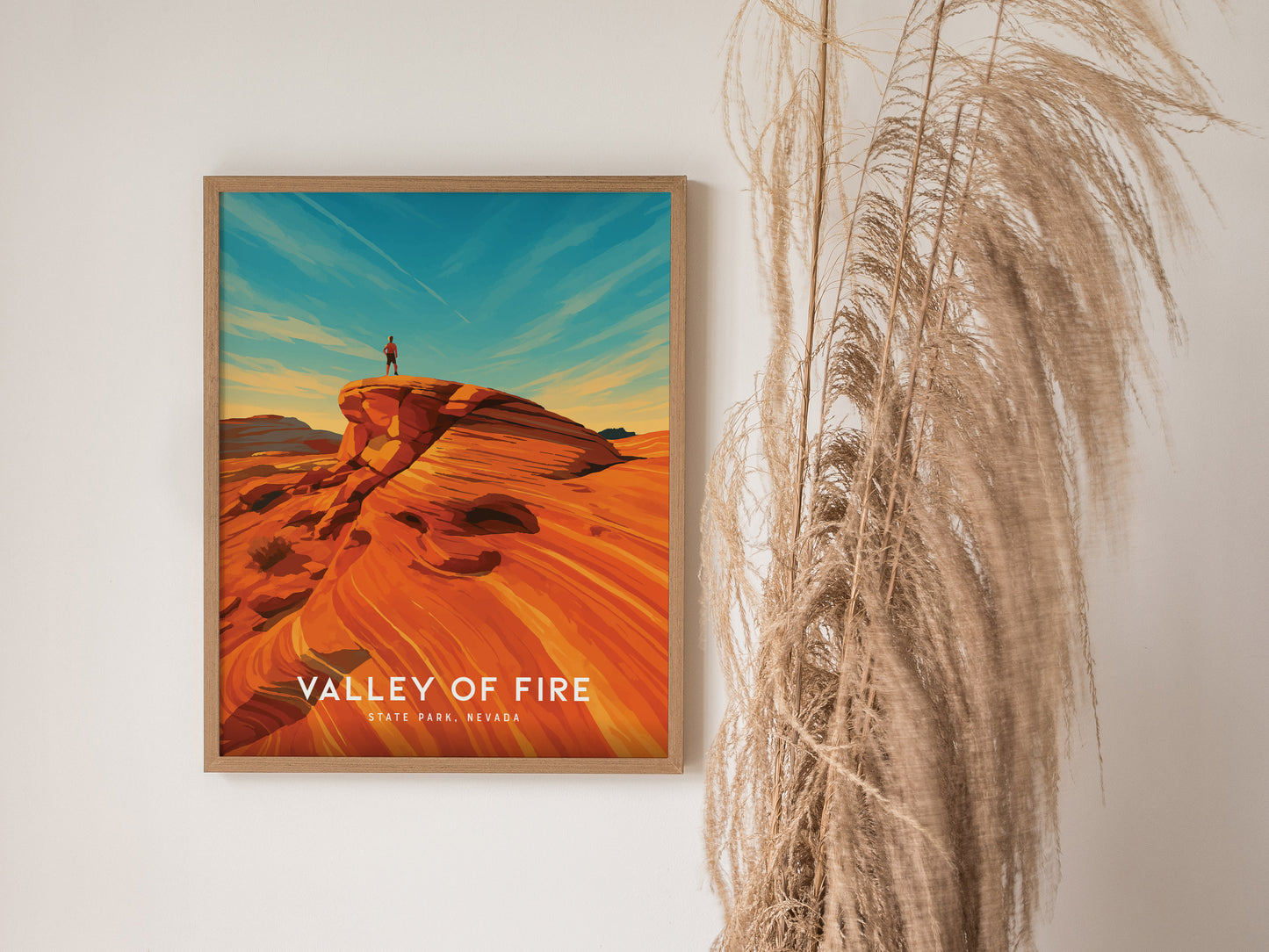Person atop a vibrant red rock formation in Valley of Fire, Nevada, showcasing bold colors and adventure in this travel art poster.