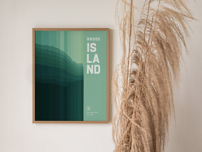 A framed poster titled Rhode Island with abstract green and teal gradients hangs on a wall beside dried pampas grass. The design is minimalist.
