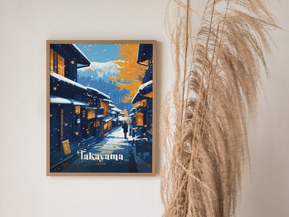 A framed poster of Takayama, Japan, showcasing traditional wooden houses under snow and autumn leaves, with distant mountains. Tall dried grasses are visible beside the artwork.