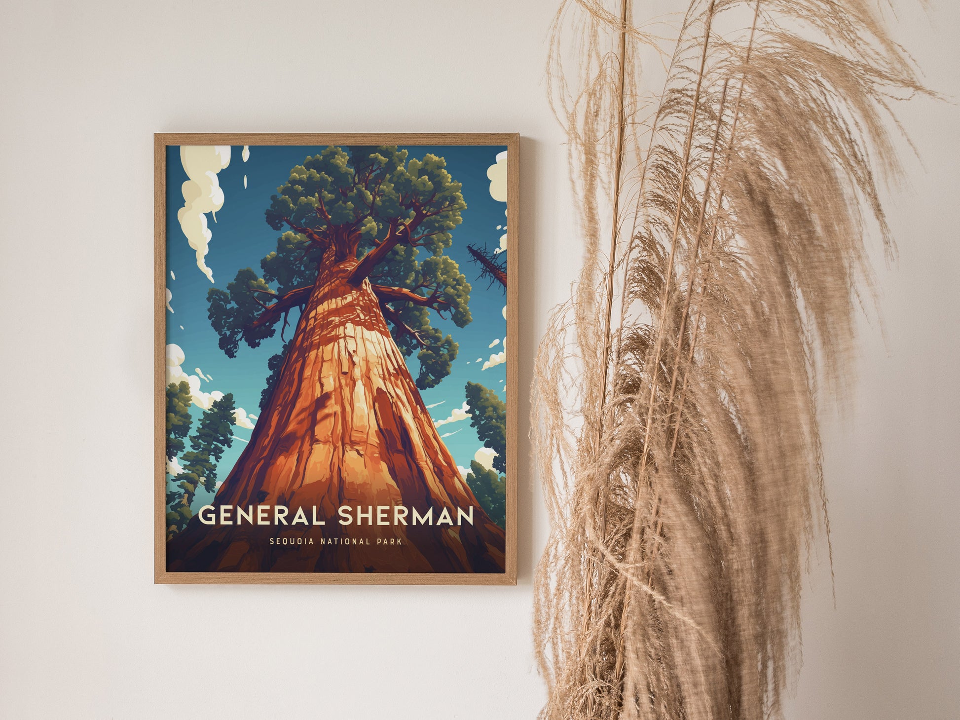 A framed poster of the General Sherman Tree from Sequoia National Park hangs on a wall, with dried pampas grass decoratively placed beside it.
