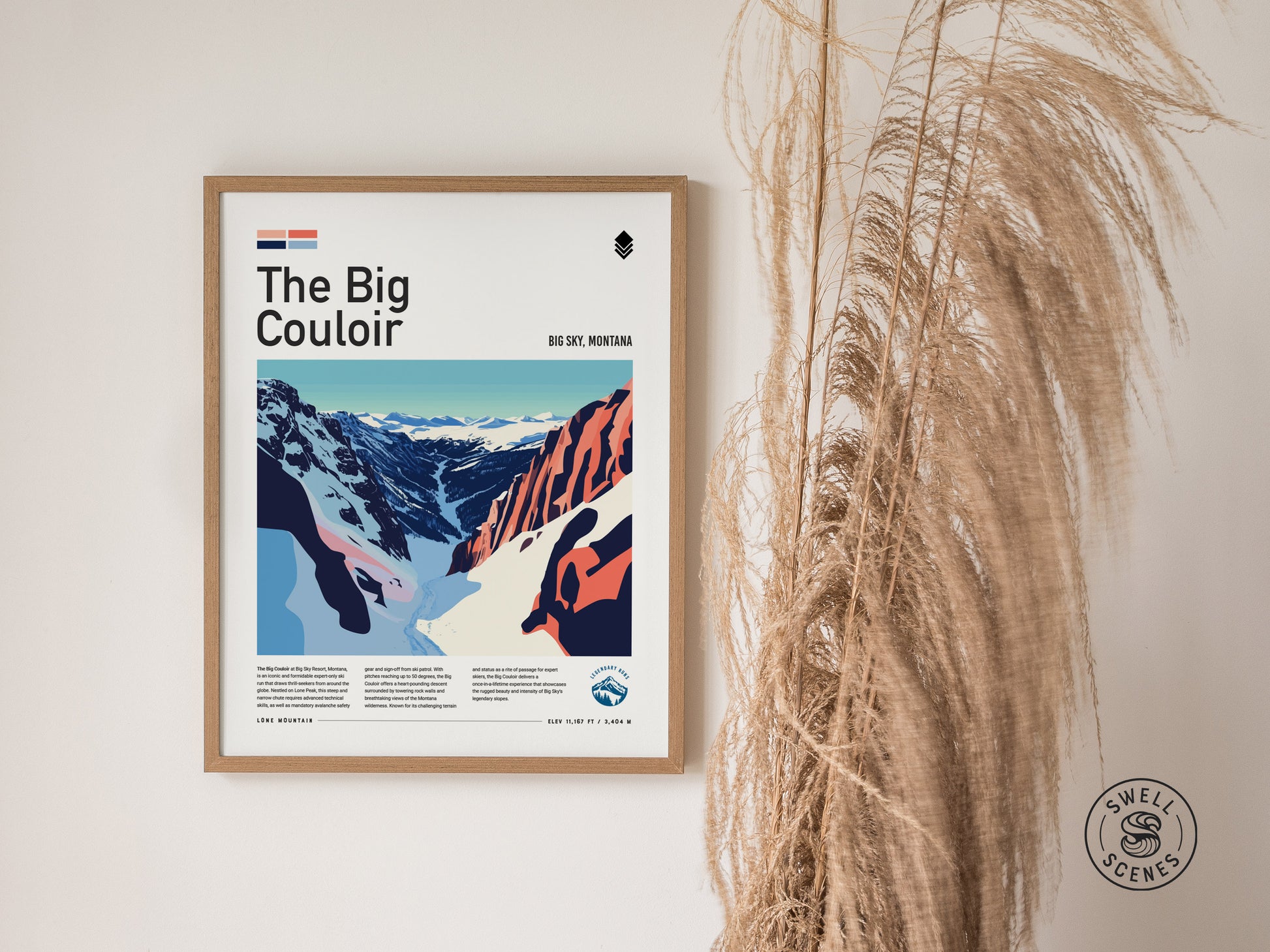 A framed poster titled The Big Couloir depicting a colorful illustration of a ski run at Big Sky, Montana, hangs on a wall beside tall, dried grasses.