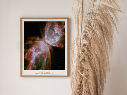 Framed Butterfly Nebula poster showcasing vibrant pink, purple, and green hues, highlighting NGC 6302's intricate cosmic details.