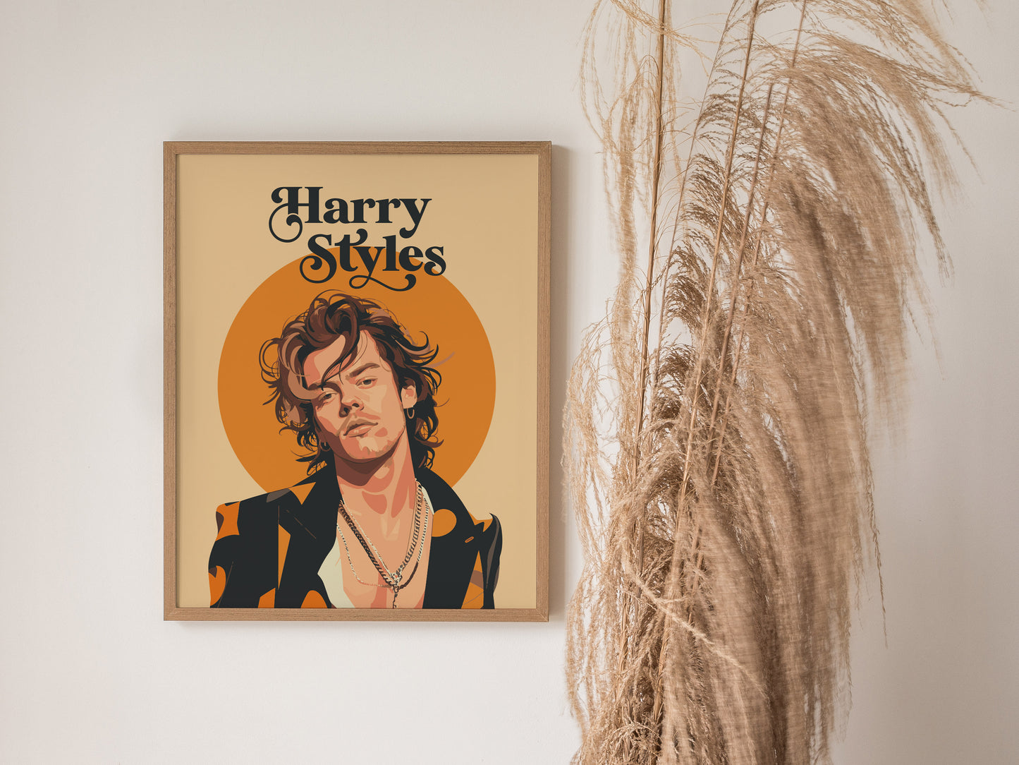 A framed poster of Harry Styles with layered necklaces and a chic jacket is displayed next to decorative dried grasses. The background features warm orange tones.
