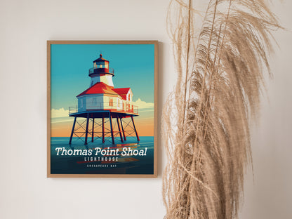 A framed poster of Thomas Point Shoal Lighthouse with vibrant colors is displayed on a wall beside decorative dried pampas grass.