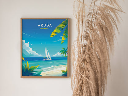 A framed poster of Aruba features a colorful illustration of a sailboat on turquoise waters, surrounded by lush greenery. Dried pampas grass is visible beside the artwork.