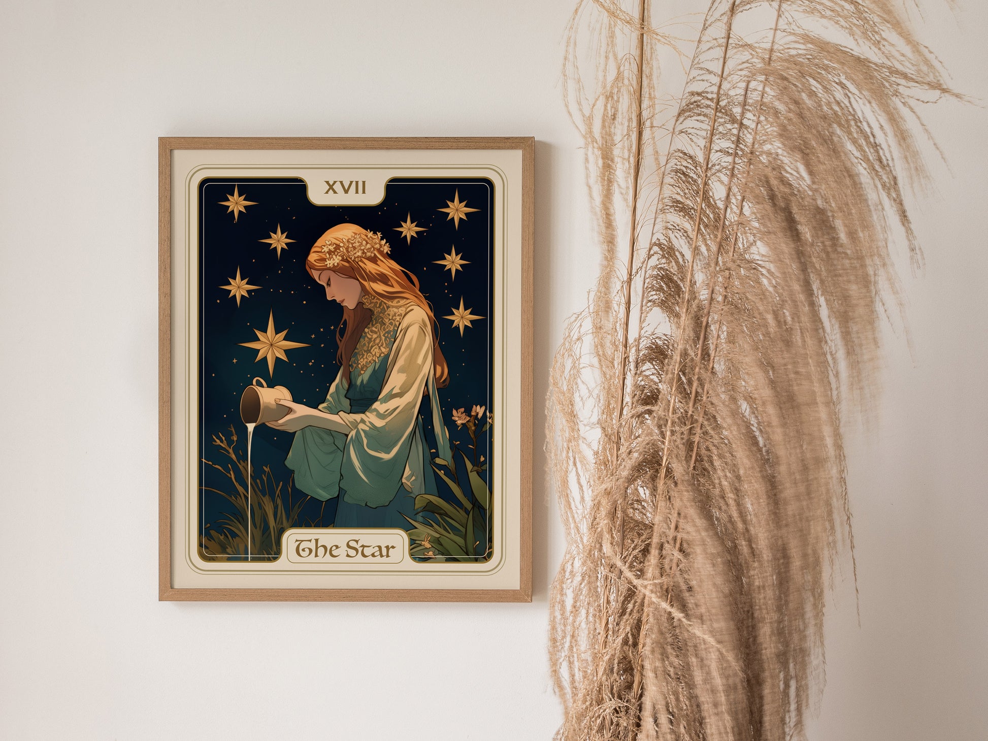 A framed poster of The Star tarot card, featuring a maiden pouring water under golden stars, hangs on a wall beside tall, dried grasses.