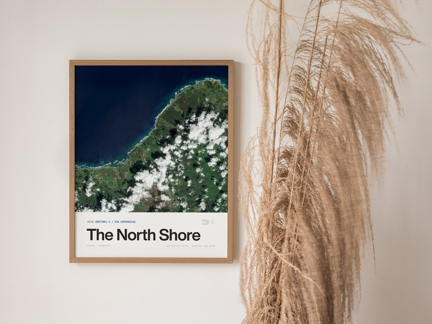 Framed satellite print of Oahu's North Shore, showcasing vibrant blues and greens of coastline, ocean, and clouds in stunning detail.