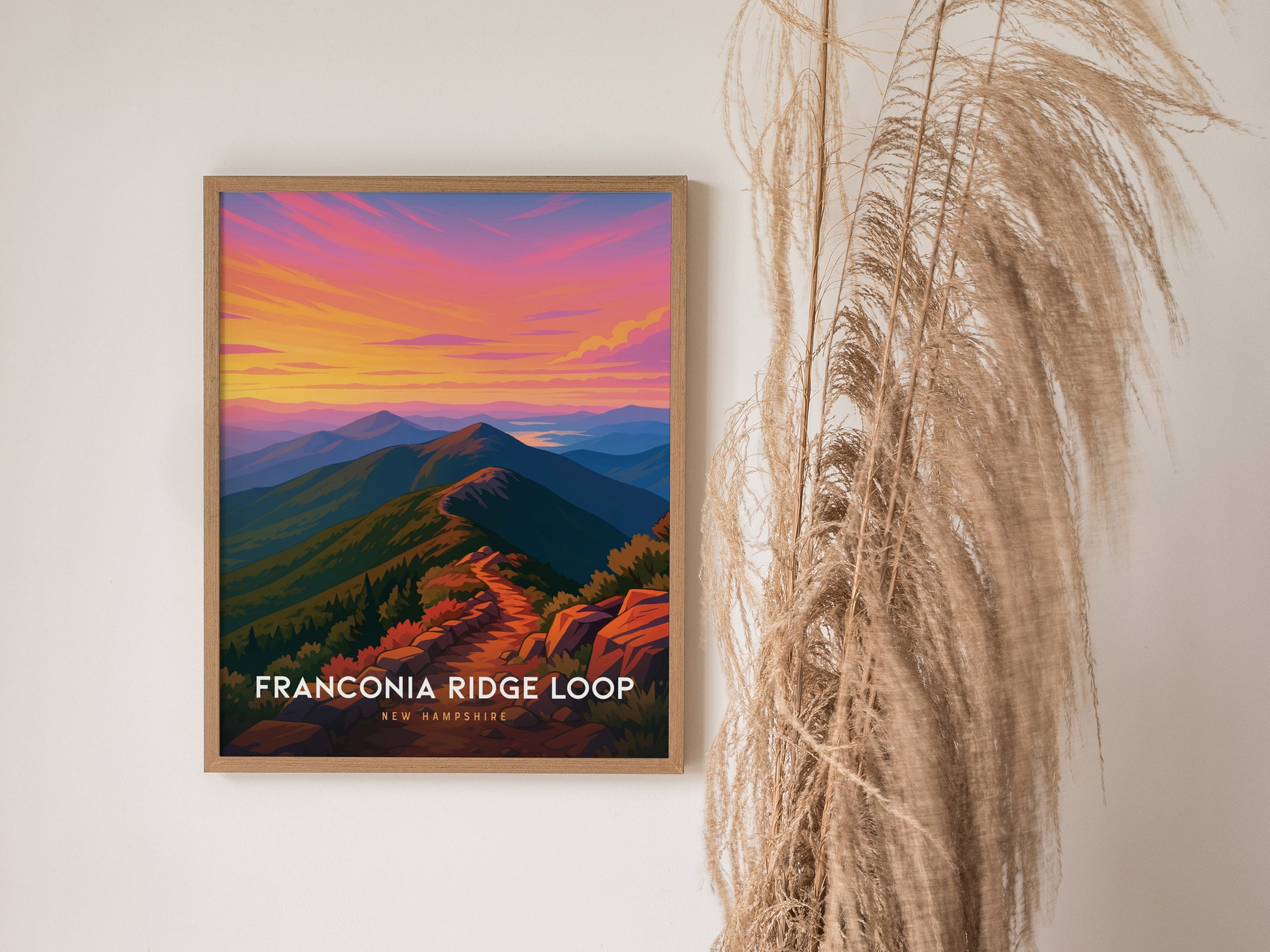 Framed Franconia Ridge Loop poster featuring vibrant sunset colors, winding trail, and stylized mountain landscape art print.