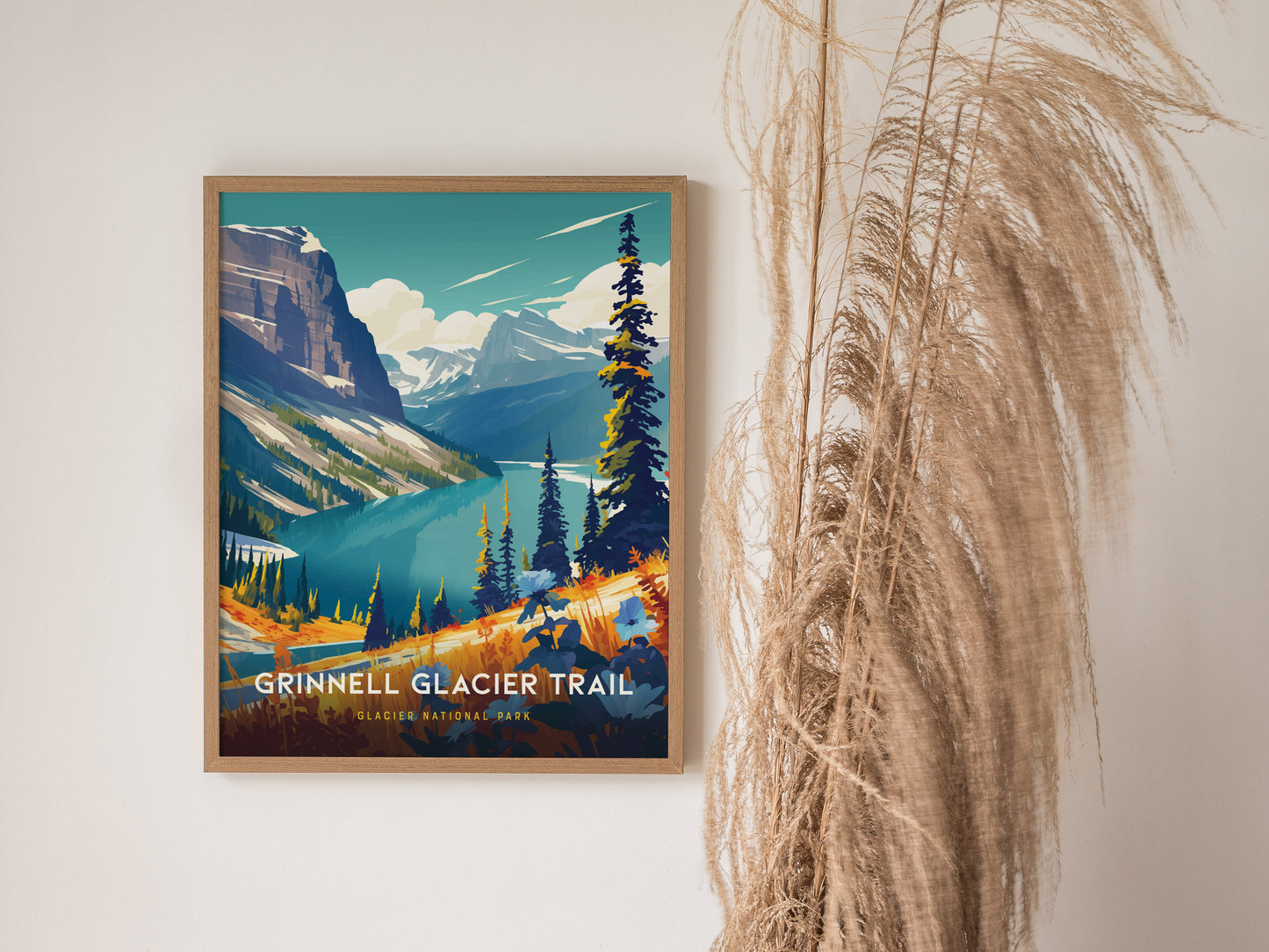 A framed poster of the Grinnell Glacier Trail features vibrant alpine scenery with turquoise lakes and towering peaks. Dried grasses are decoratively arranged beside the artwork.