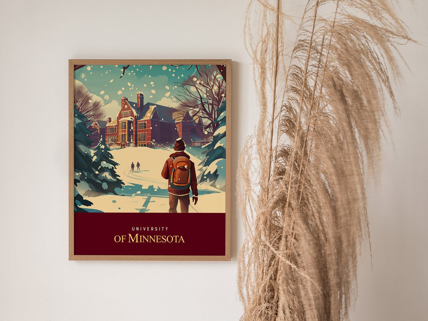 A framed University of Minnesota poster depicts a snowy campus scene with a student walking towards a historic building, surrounded by trees. Pampas grass decorates the right side.