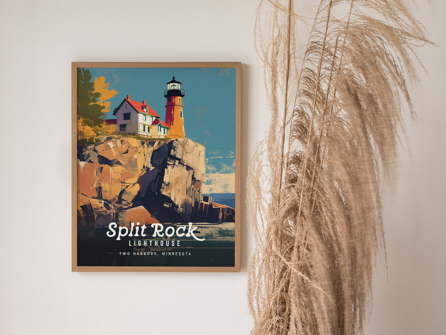 A framed poster of Split Rock Lighthouse is displayed on a wall, featuring a colorful illustration of the lighthouse on rocky cliffs. Decorative pampas grass is visible nearby.