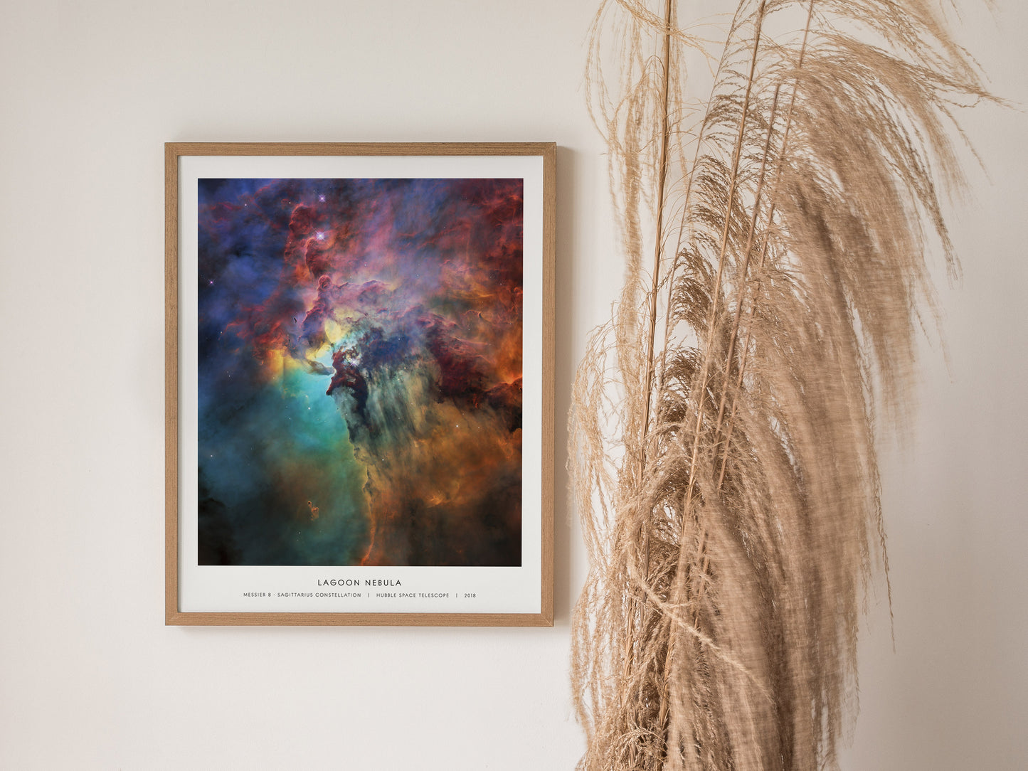 Vibrant Lagoon Nebula print in blues, reds, and purples, framed with "Messier 8, Sagittarius Constellation" label, ideal space art.