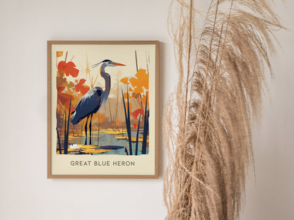 Framed illustration of a Great Blue Heron standing in a wetland, surrounded by orange and brown foliage. The background features water with lily pads, adding a serene atmosphere.