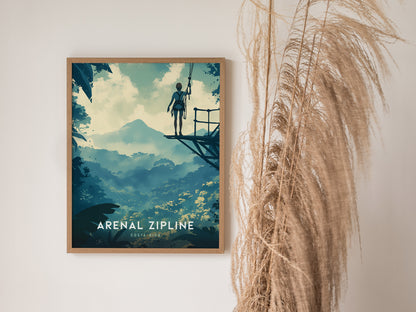 A framed poster of a person on a zipline platform in a lush, mountainous landscape, with Arenal Zipline Costa Rica text. Dried plants are visible beside the poster.