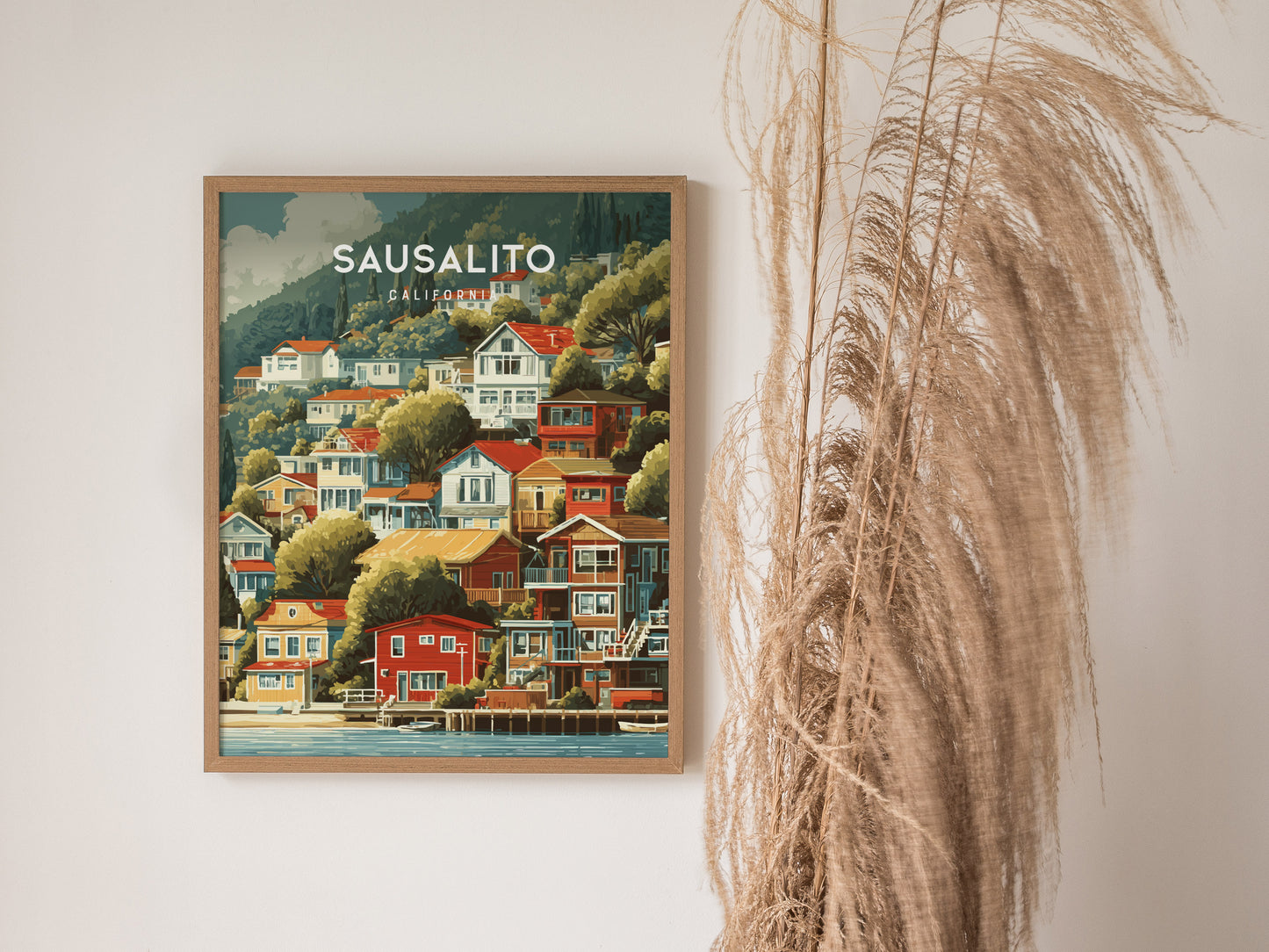 Framed vintage Sausalito, California poster featuring colorful hillside houses, lush greenery, and a tranquil coastal scene.