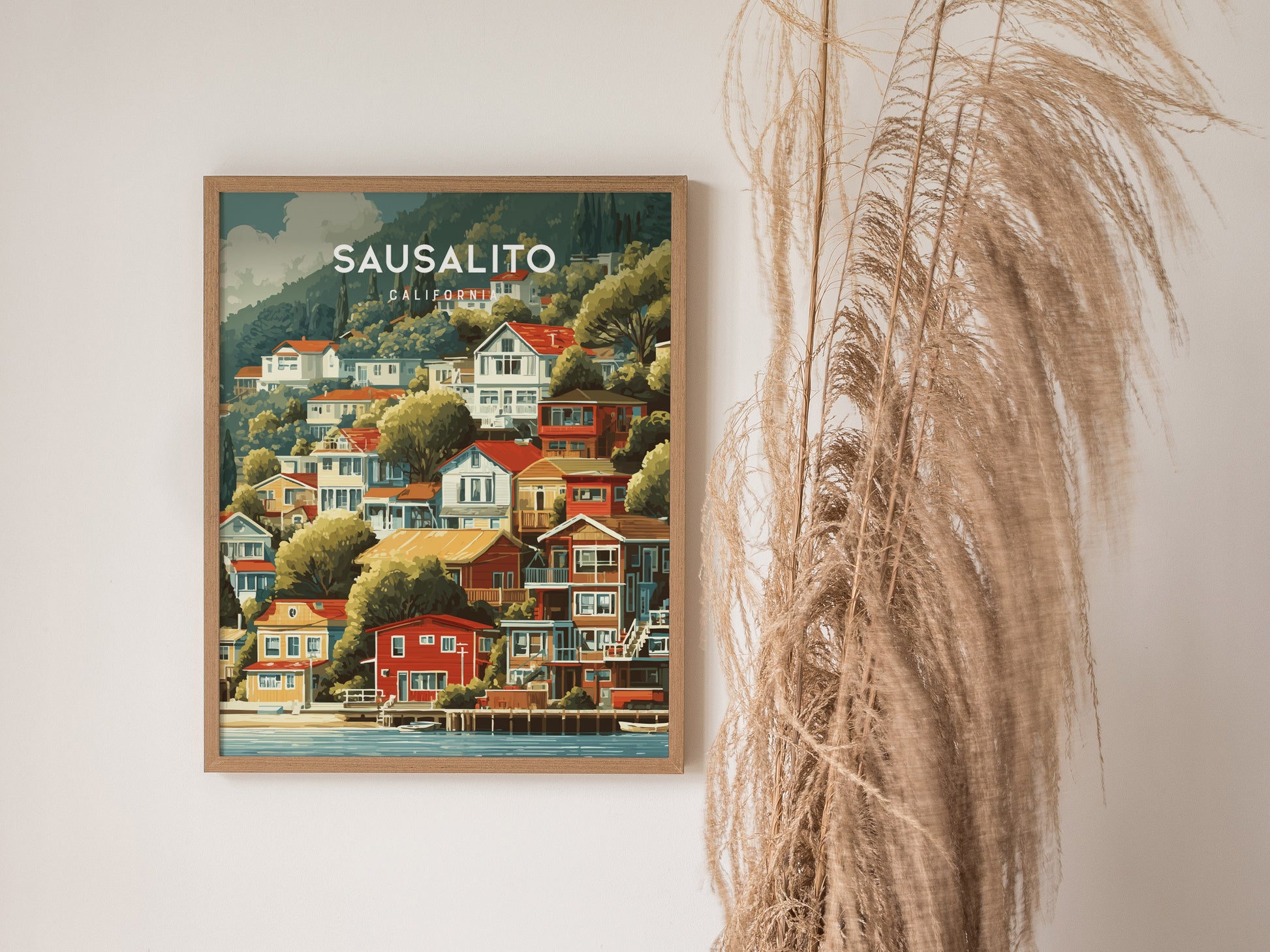 Framed vintage Sausalito, California poster featuring colorful hillside houses, lush greenery, and a tranquil coastal scene.