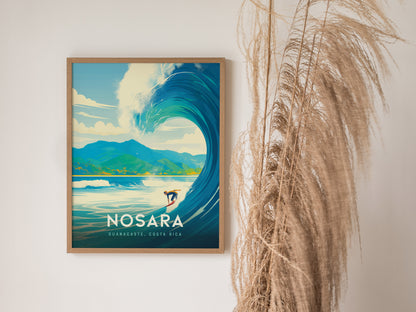 Framed poster of a surfer riding a large wave with mountains in the background, labeled Nosara, Guanacaste, Costa Rica, next to decorative dried grasses.