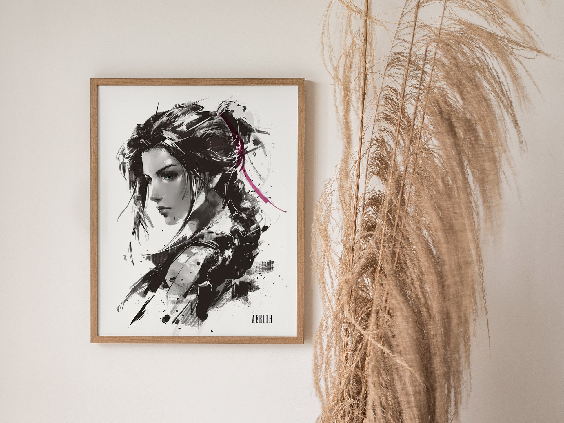 A framed monochrome portrait of a woman with braided hair and a pink ribbon, displayed on a wall beside tall, dried grasses.