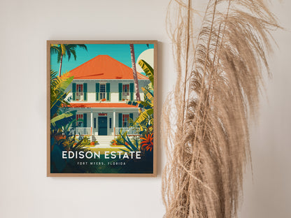 A framed poster of the Edison Estate in Fort Myers, Florida, featuring a white house with a red roof, surrounded by lush tropical plants. Pampas grass decorates the side.