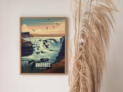 A framed poster of Gullfoss waterfall in Iceland shows cascading water under a pastel sky with birds flying. Tall, dried grasses are placed beside it for decorative effect.