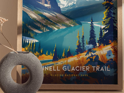 A colorful poster of the Grinnell Glacier Trail features vibrant alpine scenery with turquoise lakes and towering peaks. A round, textured vase with dried flowers is in the foreground.