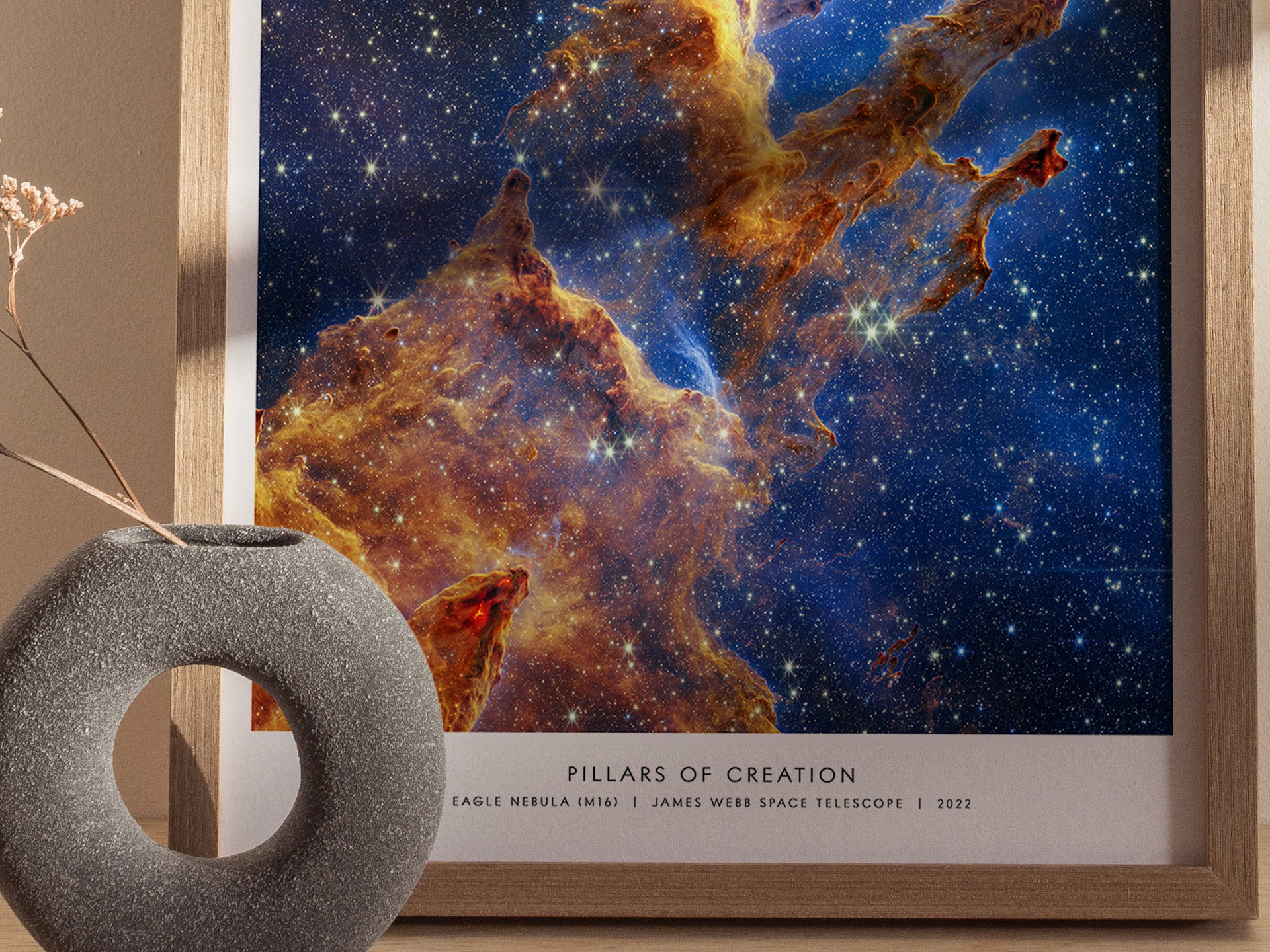 Close-up view of the framed Pillars of Creation JWST artwork showing detailed nebula textures, golden pillars, and sparkling stars.