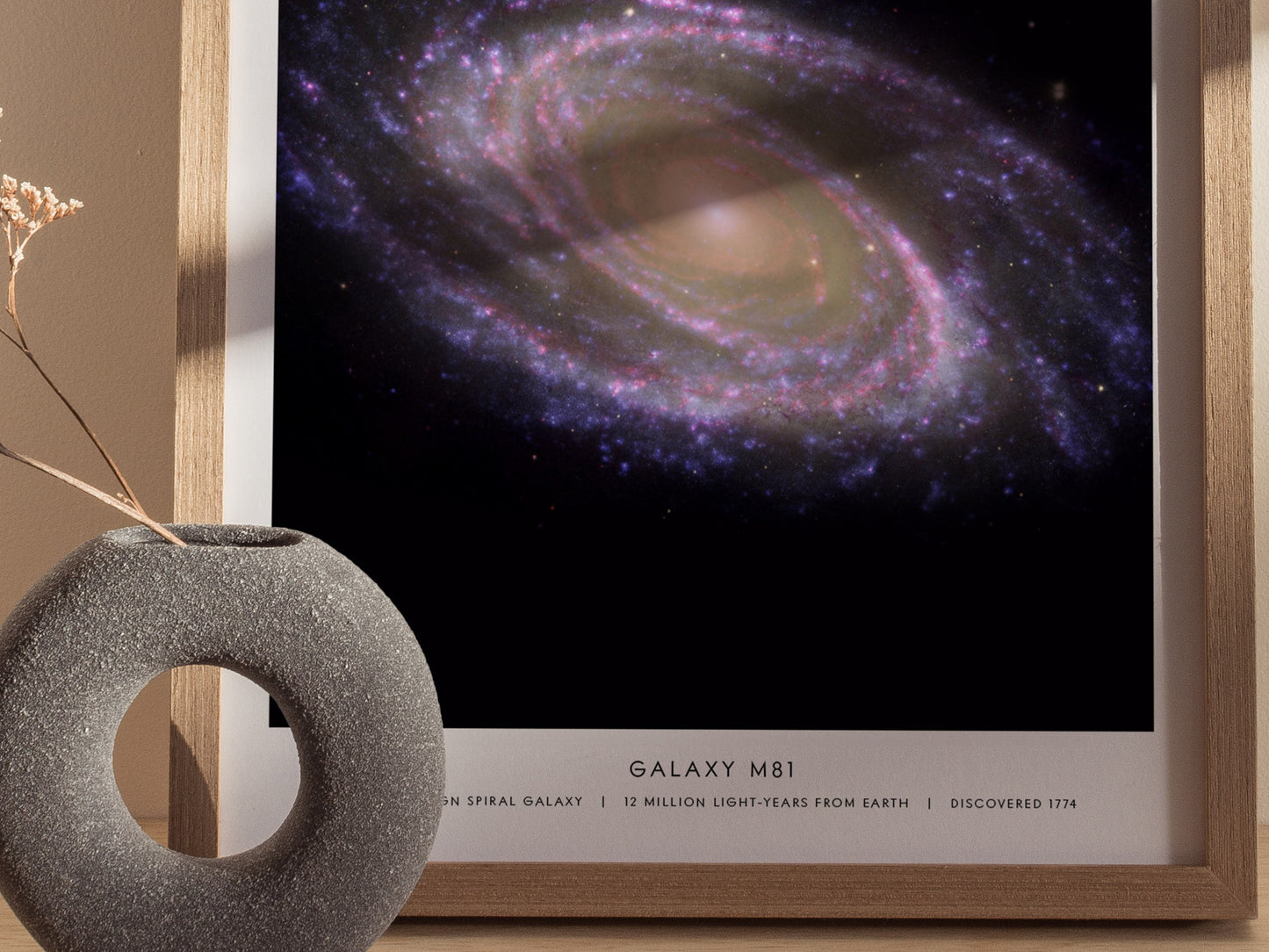 Close up of M81 galaxy poster showing bright core, spiral arms, and surrounding star field