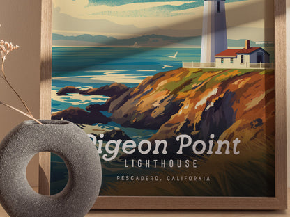 A framed poster of Pigeon Point Lighthouse shows a vibrant coastal scene with cliffs and ocean waves. A gray circular vase with dried flowers is in the foreground.