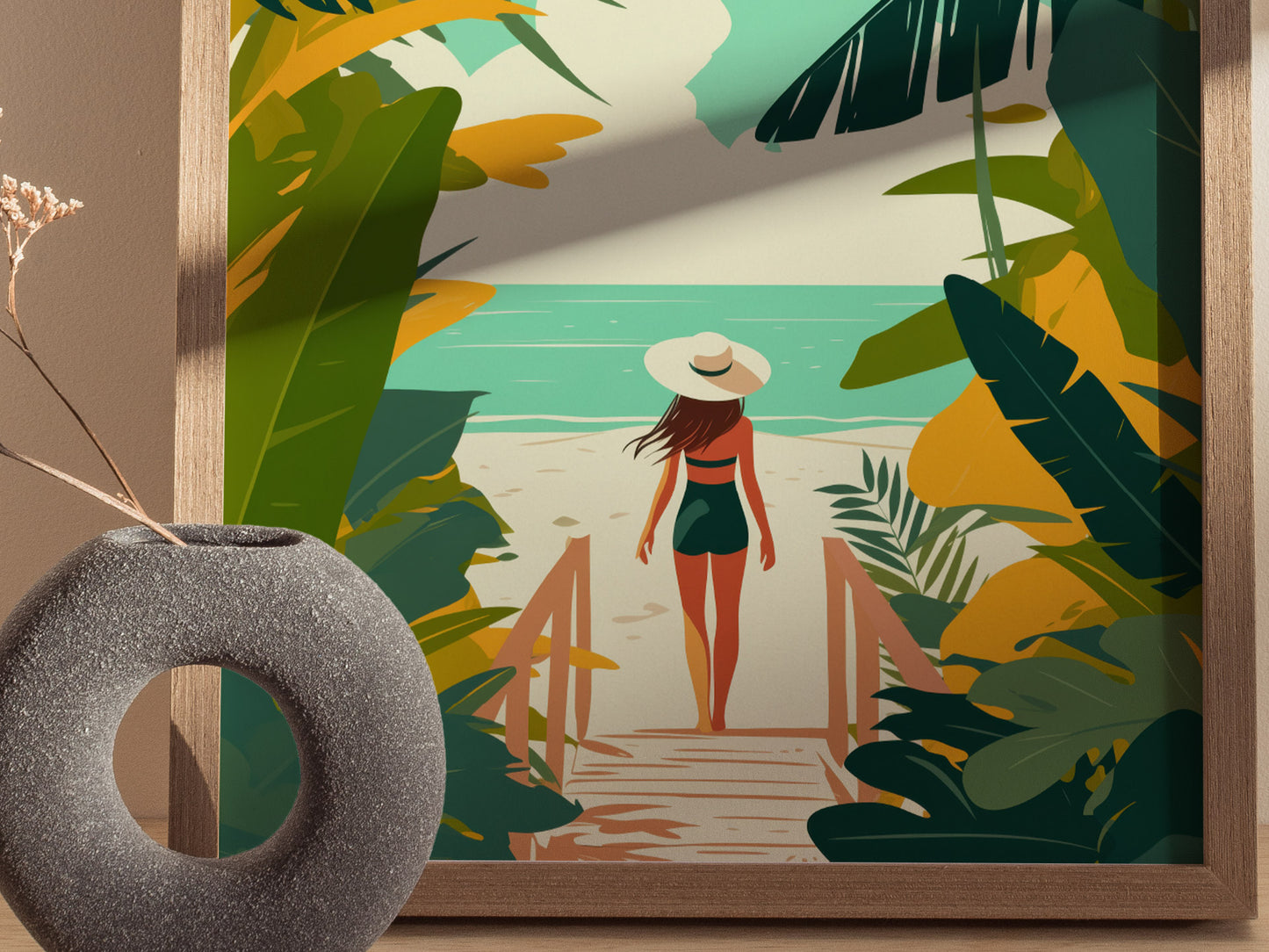 A framed artwork depicts a woman in a hat walking toward the ocean, surrounded by vibrant tropical foliage. A textured gray vase with dried flowers sits nearby.