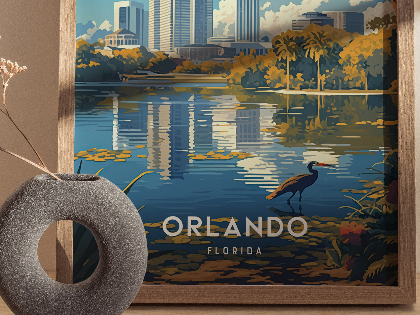 A framed poster depicting Orlandos downtown skyline with a serene lake reflecting buildings, vibrant trees, and a heron in the foreground. Text reads Orlando Florida.