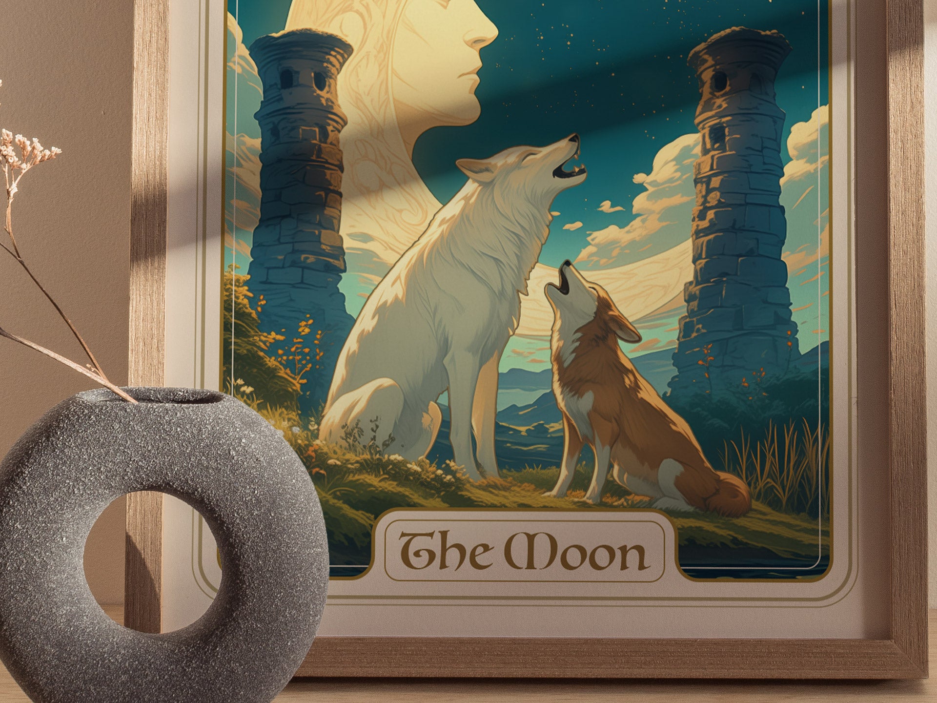 A framed poster titled The Moon depicts a white wolf and a brown dog howling beneath a crescent moon between two ancient pillars, with a vase in the foreground.