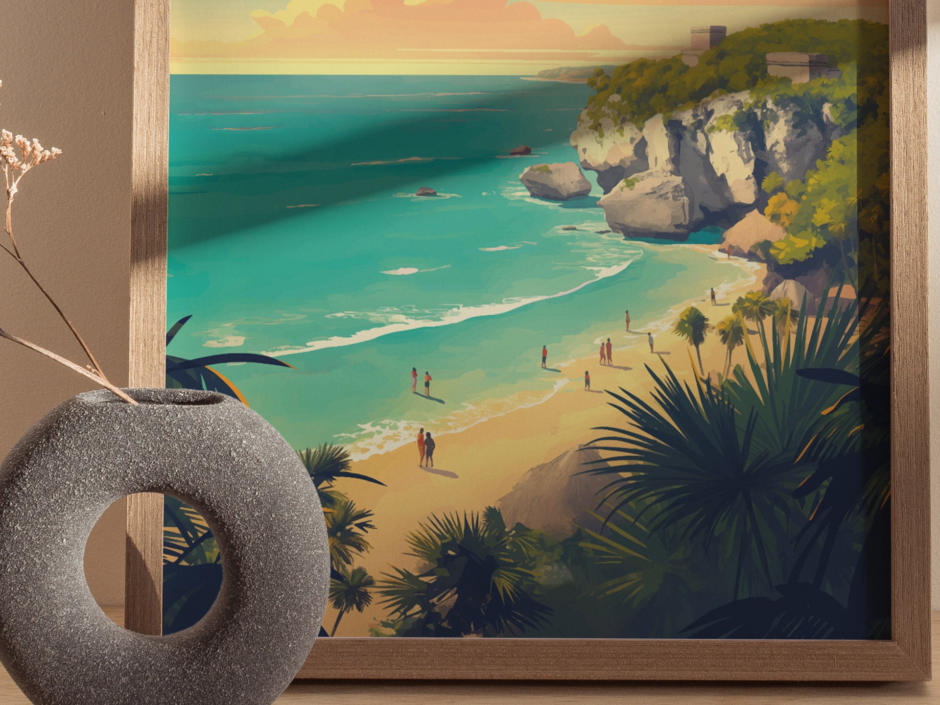A framed artwork depicting a scenic beach with turquoise waters, cliffs, and people walking along the shore. A textured round vase with dried flowers is partially visible in the foreground.