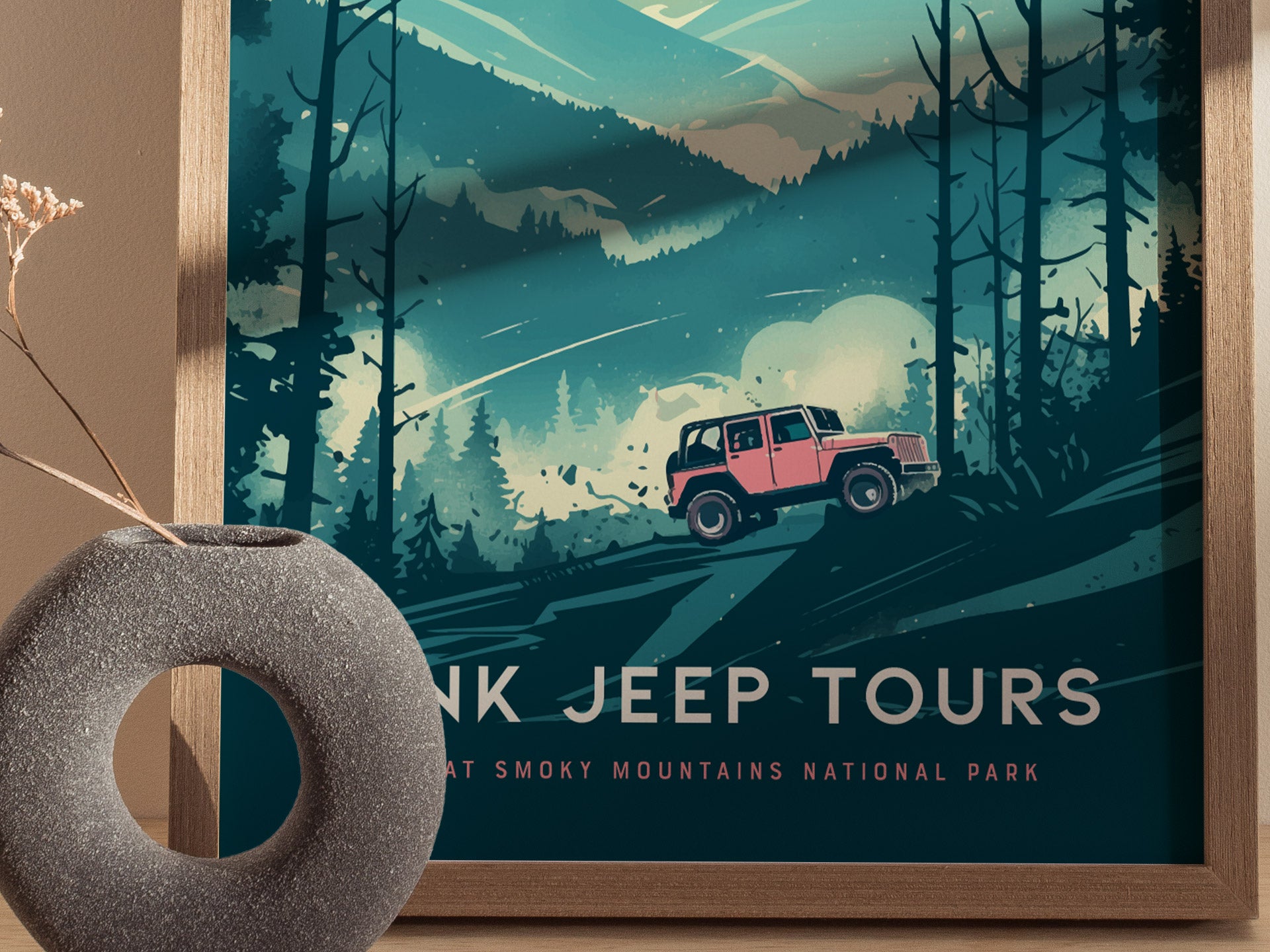 A framed poster features a vibrant pink jeep driving through a rugged, misty landscape with tall trees and mountains in the background, labeled Pink Jeep Tours for the Great Smoky Mountains National Park.