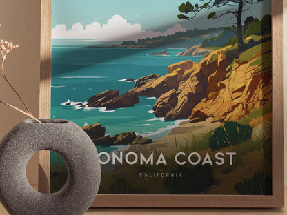 A framed poster depicting a stylized Sonoma Coast scene with rocky cliffs, ocean waves, and vibrant greenery. A round, textured vase with dried flowers is in the foreground.