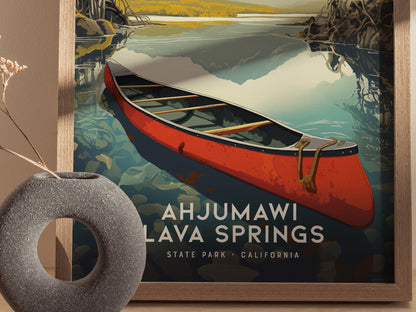 A framed poster of Ahjumawi Lava Springs features a red canoe on serene waters, with detailed reflections and natural surroundings. A round, textured vase sits nearby.