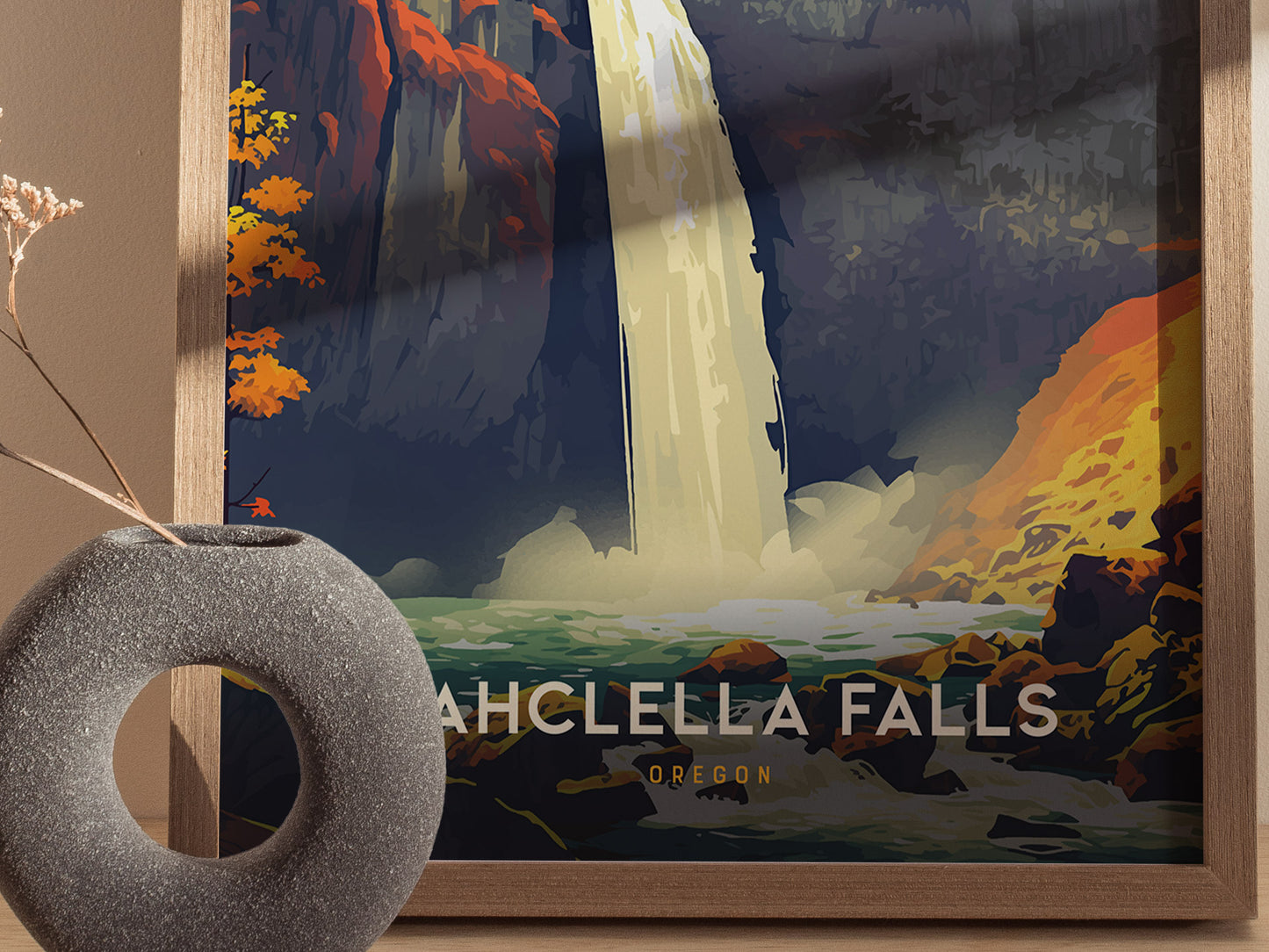 A framed poster of Wahclella Falls features a vibrant illustration of a waterfall cascading through colorful cliffs. A textured gray vase with dried flowers is positioned in the foreground.