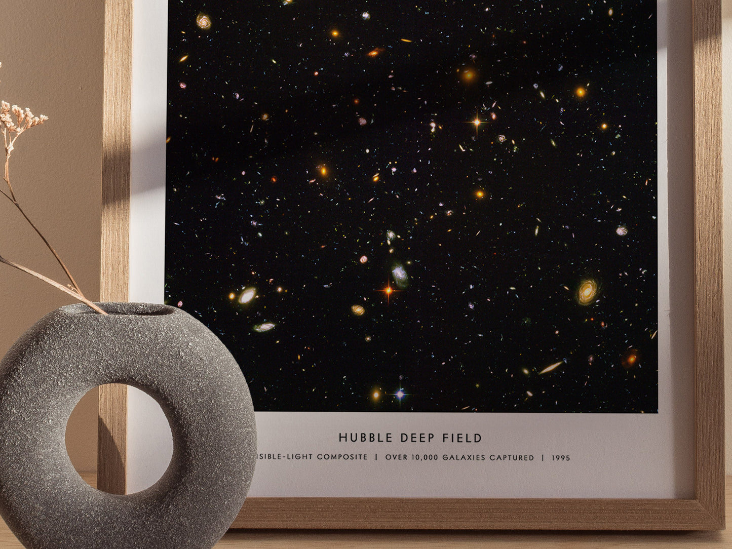 Close up of Hubble Deep Field poster highlighting colorful distant galaxies on a dark background