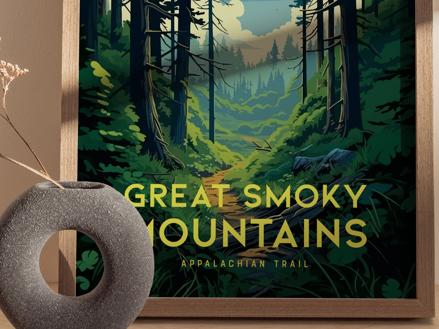 A framed poster of the Great Smoky Mountains, featuring a lush forest trail under a cloudy sky. A circular stone vase with dried flowers is placed in front.
