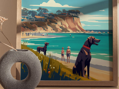 A framed illustration depicts a vibrant beach scene with two dogs, people walking, and dramatic cliffs in the background. A vase with dried flowers sits beside the artwork.