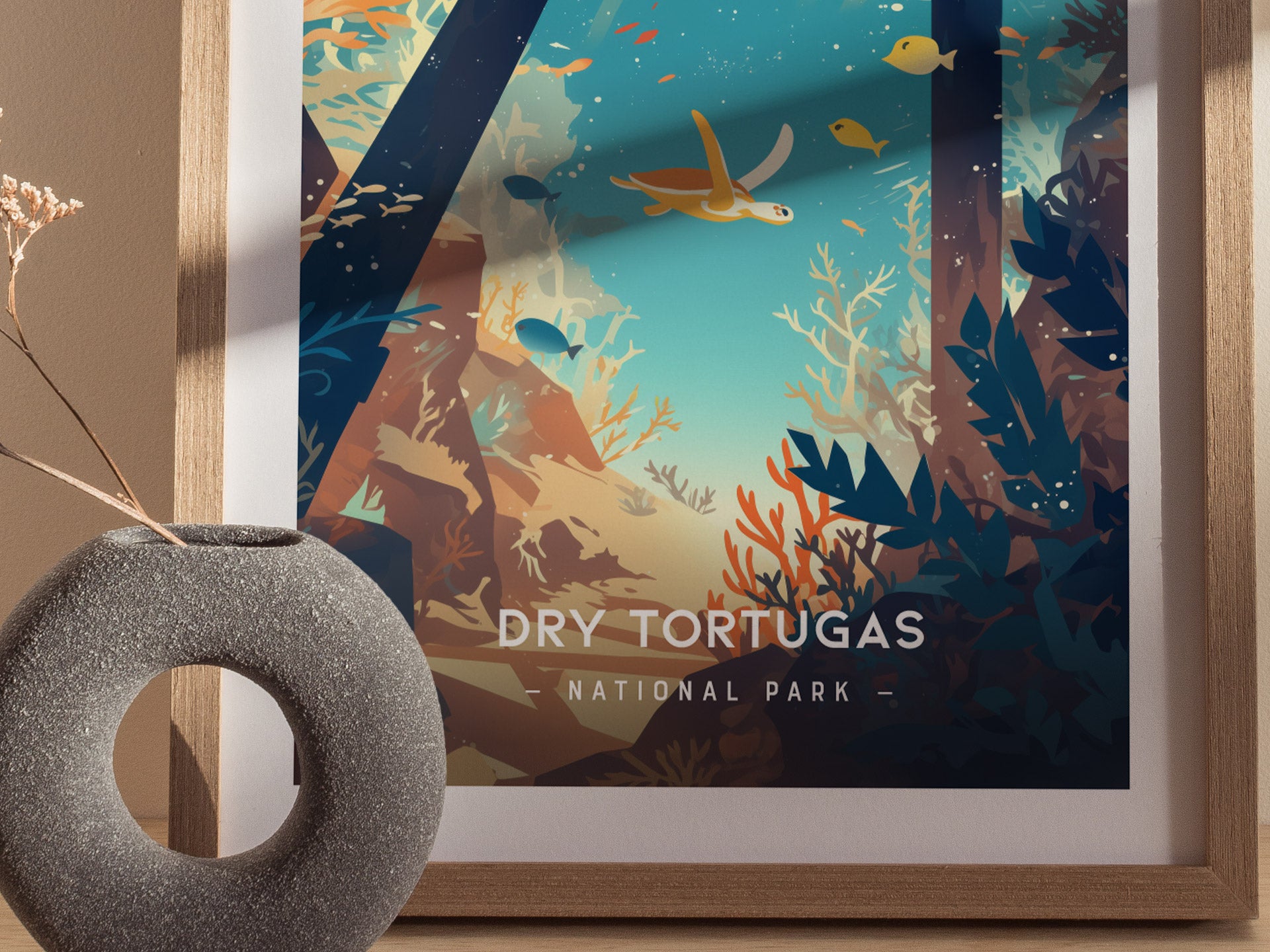 A framed minimalist poster of Dry Tortugas National Park features vibrant marine life and coral reefs, with a sea turtle swimming amidst colorful fish.