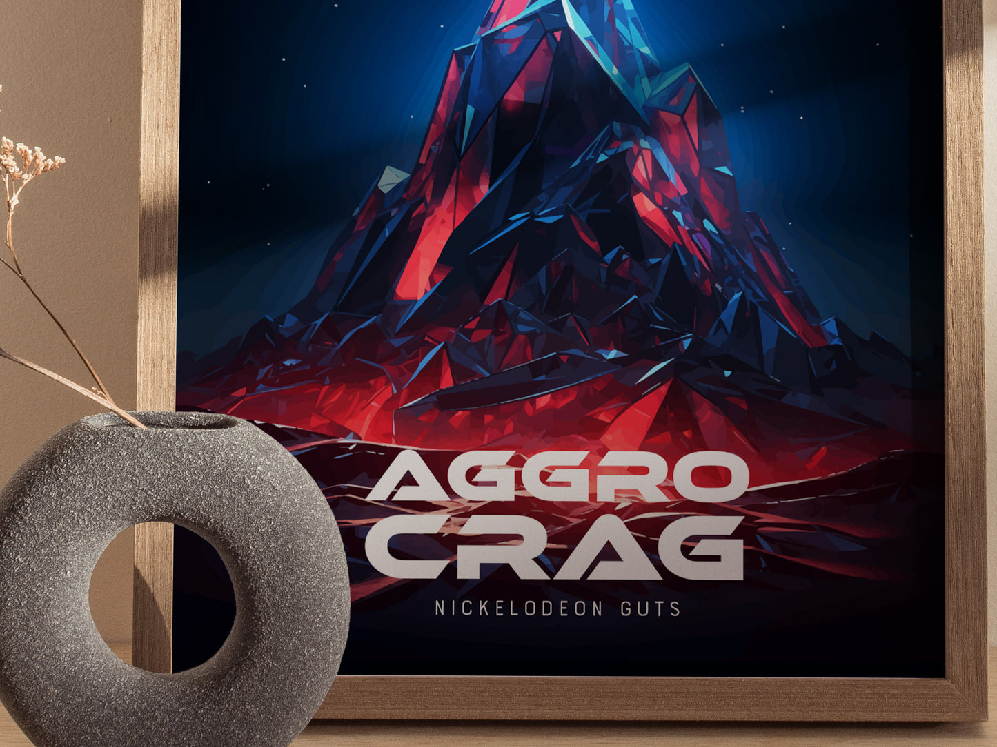 A poster featuring a stylized, colorful mountain with the text Aggro Crag Nickelodeon GUTS in bold letters. A round, textured vase with dried flowers sits in front.
