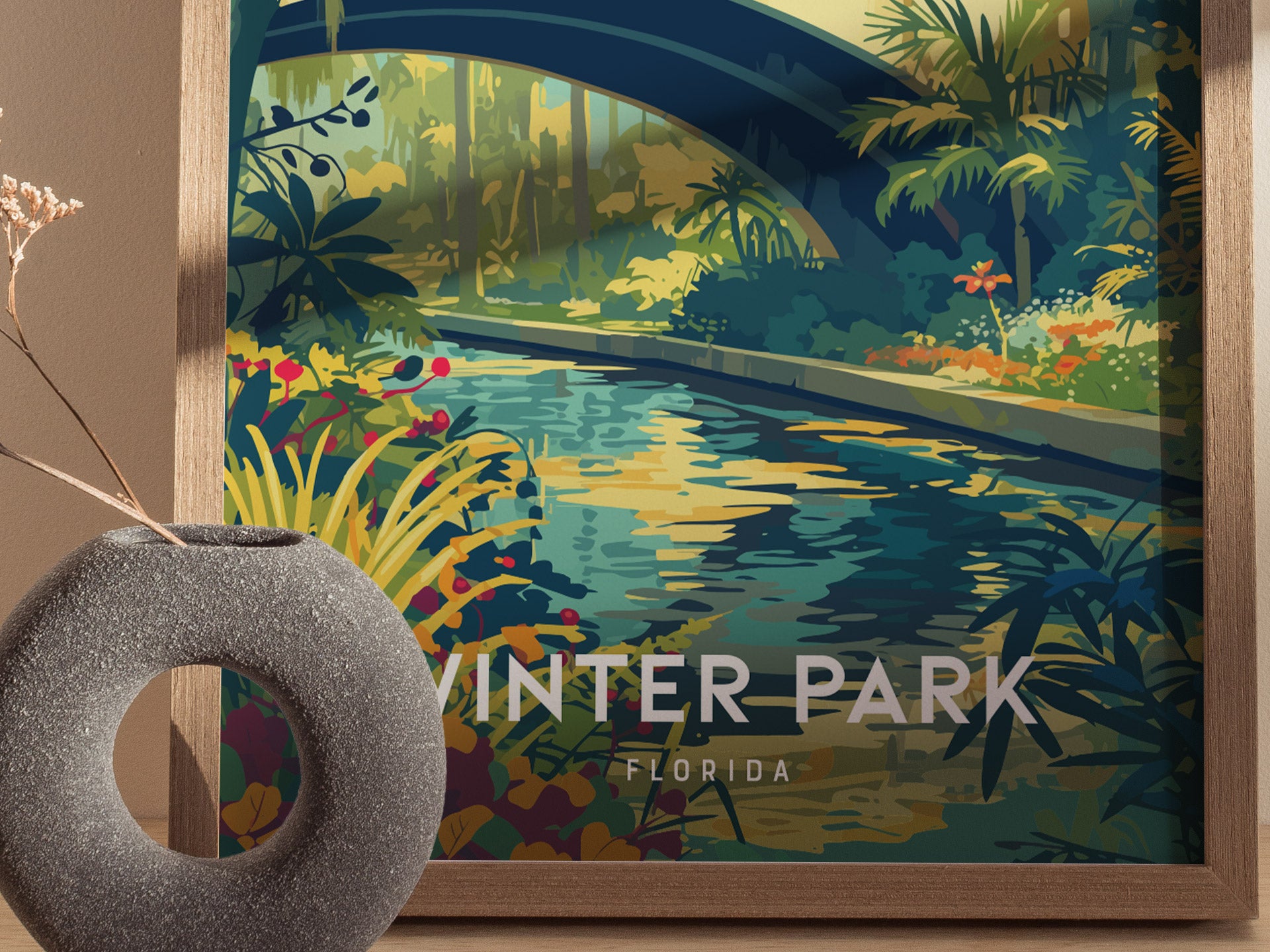 A vibrant illustration of a lush garden with a stream flowing under a blue arching bridge, surrounded by tropical plants and flowers. Text reads Winter Park Florida.