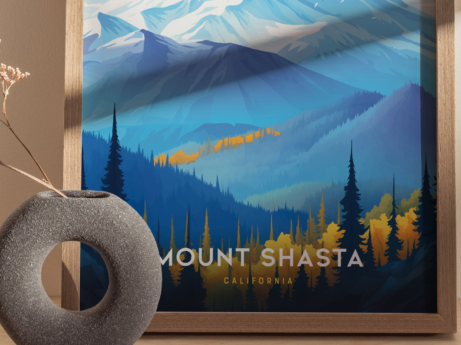 A framed Mount Shasta poster features a stylized depiction of the volcano with snow-capped peaks, vibrant blue and orange forested foothills.