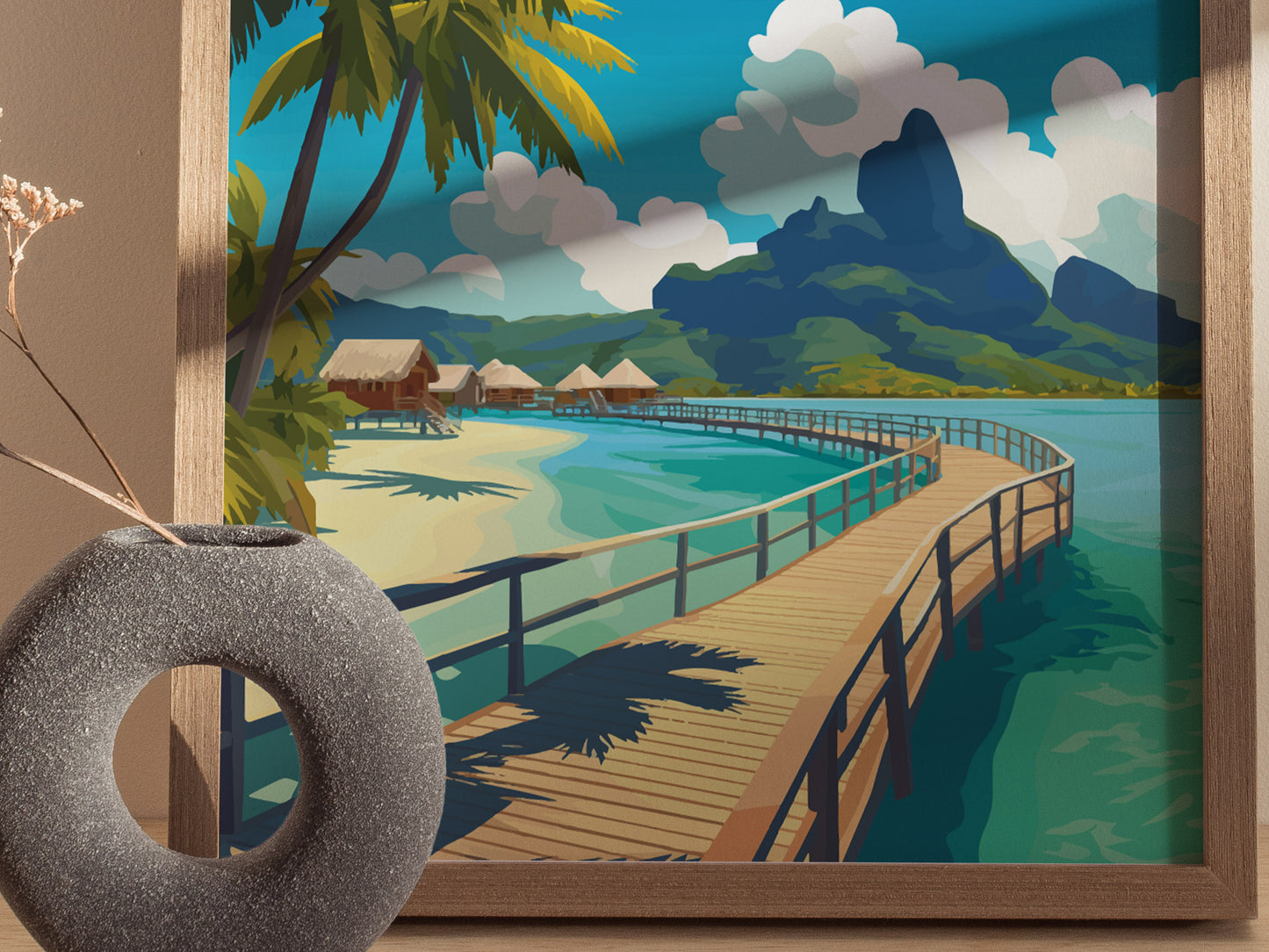 Framed artwork depicting a tropical paradise with a wooden walkway over turquoise waters, leading to overwater bungalows, lush greenery, and dramatic mountains under a blue sky.