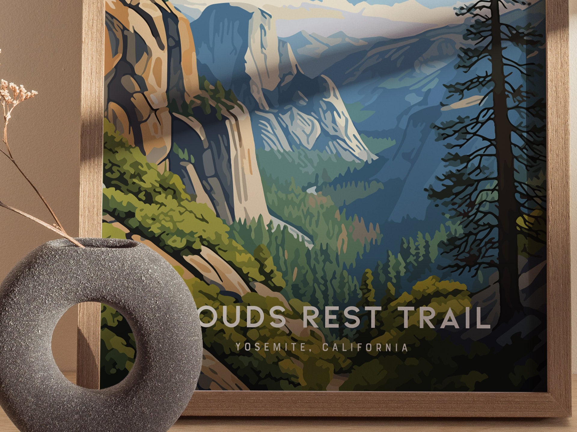 Framed poster of Clouds Rest Trail in Yosemite, featuring stylized granite cliffs and valleys under a blue sky, with a textured gray vase in the foreground.